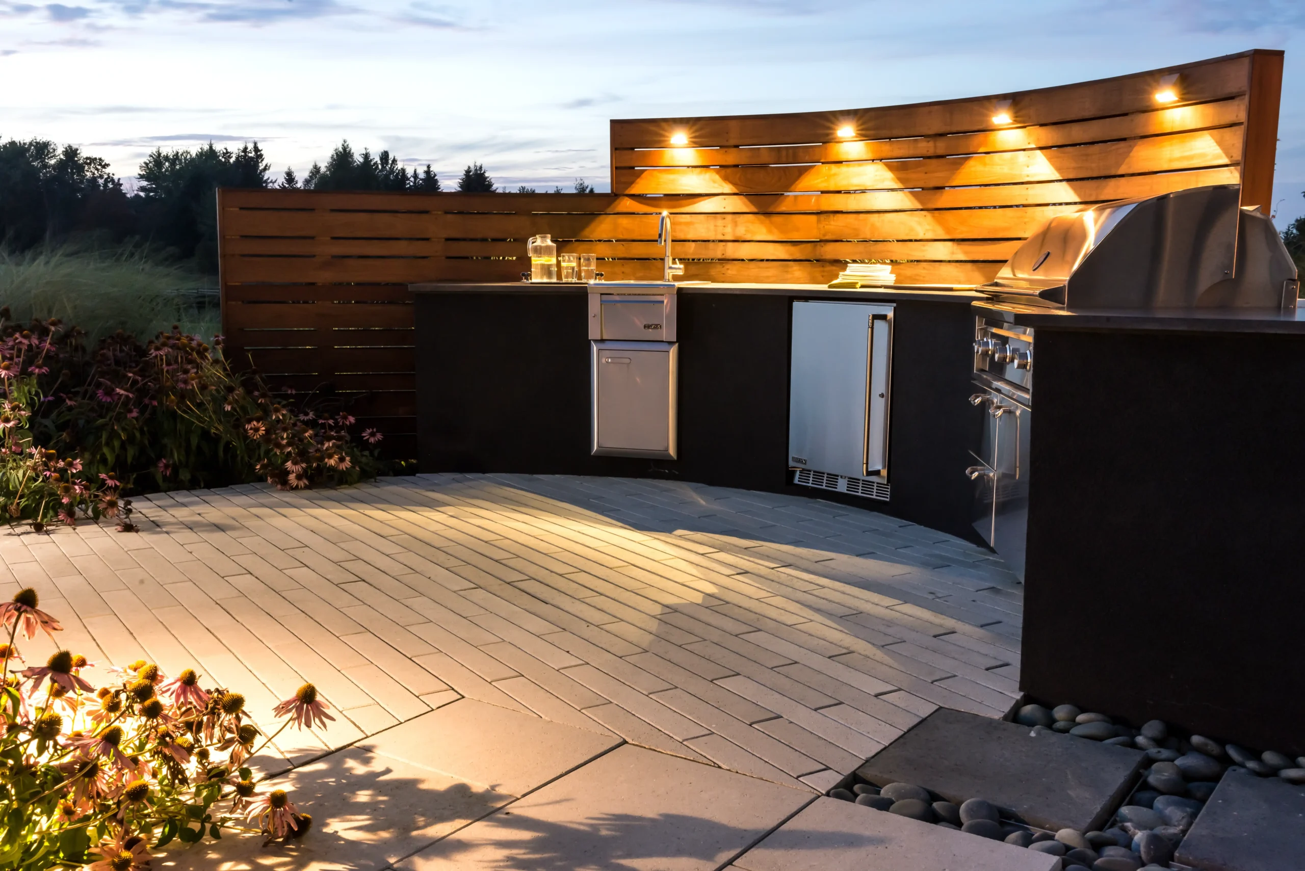 Outdoor kitchen with grill and paved dining patio